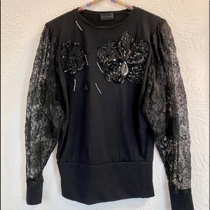 Black top with lace sleeves, sequins, rhinestones!